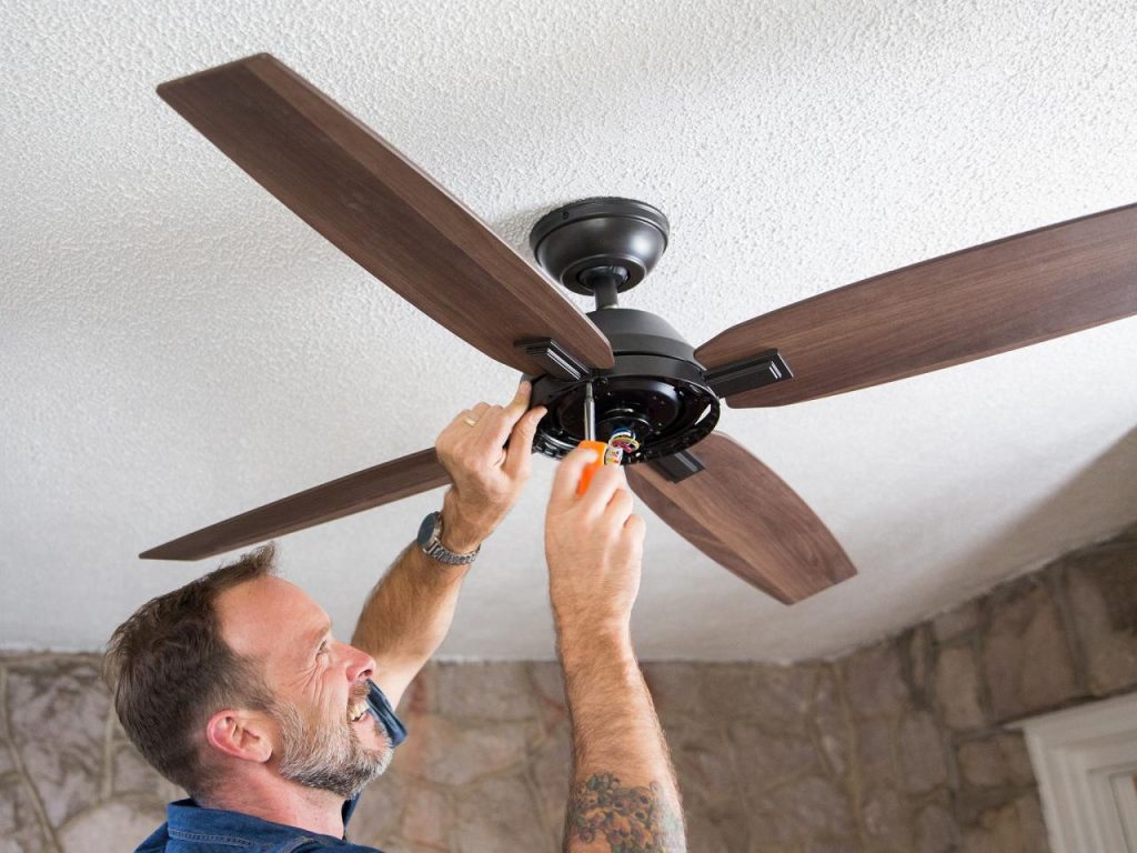 an electrician is hired to install a ceiling fan